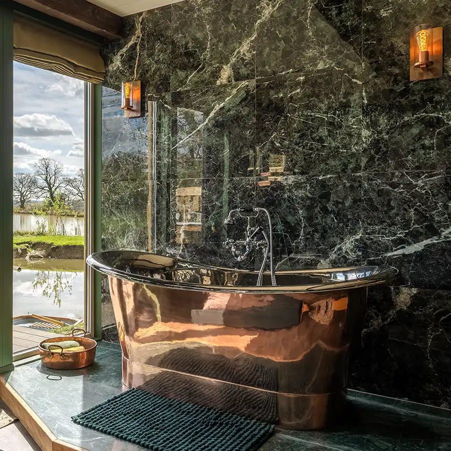 luxury bathroom installation by homeguard heating with copper roll top bath